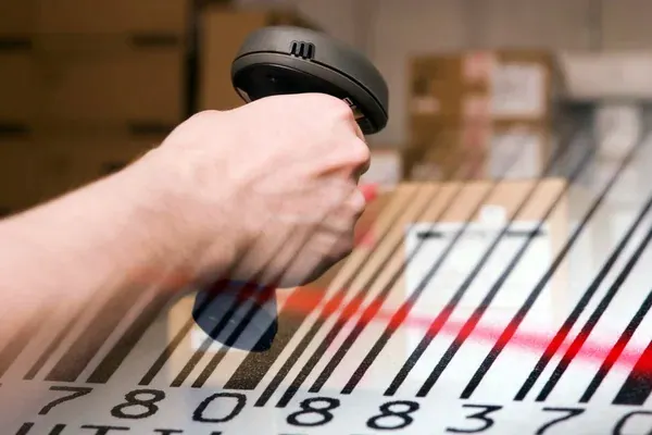 primer plano de mano utilizando un lector de código de barras para el conteo de inventario